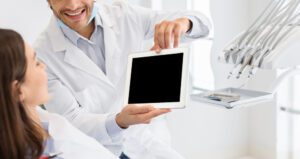 Cropped image of dentist showing blank digital tablet screen